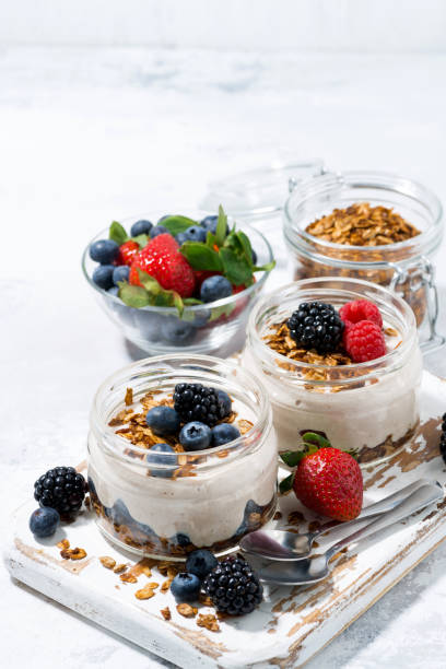 istock healthy creamy dessert with fresh berries on white background, vertical 1143501215