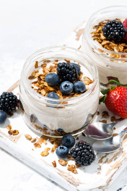 istock healthy creamy dessert with fresh berries on white board, top view 1143501229
