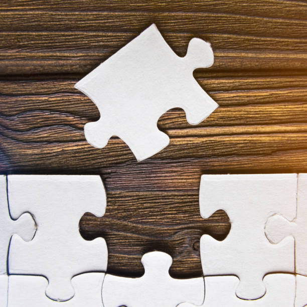 istock puzzles on a wooden background. 1143503867