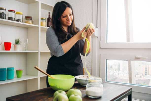 istock Young woman peeling apples 1143504907