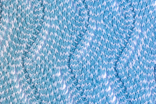 istock Knitted zigzag pattern close up. The texture of wool products. Blank blue background for layout. 1143505297