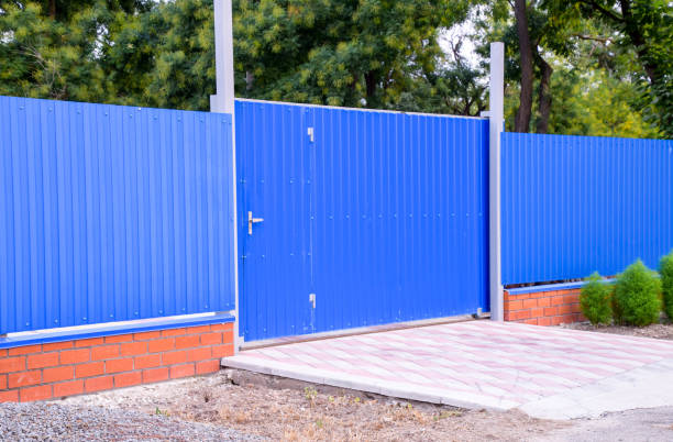 istock Fence and gate from sheets of blue corrugated metal. 1143505933