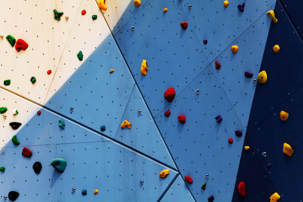 Multicolored climbing holds and volumes marked with climbing magnesium chalk.