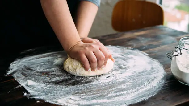 Woman kneading dough. Close Up