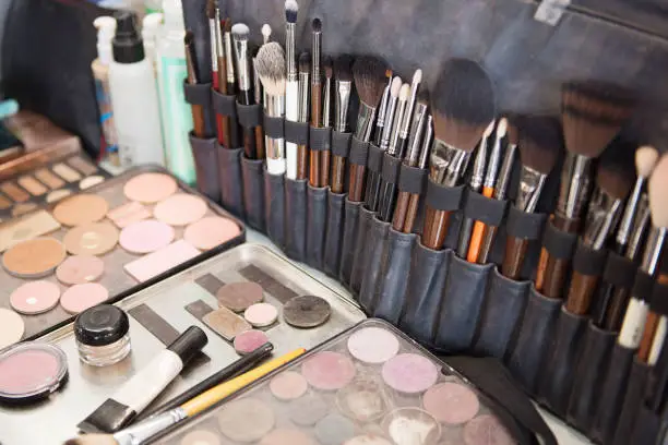 Photo of Various makeup brushes. Collection of Eye shadows, rouges.