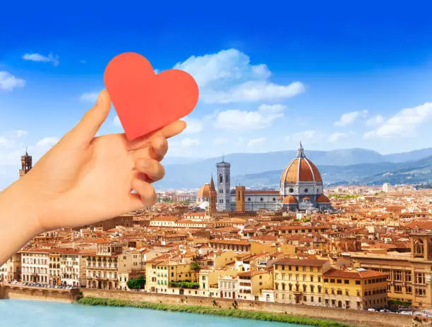 Photo of Hand hold red heart over Florence and Saint Mary