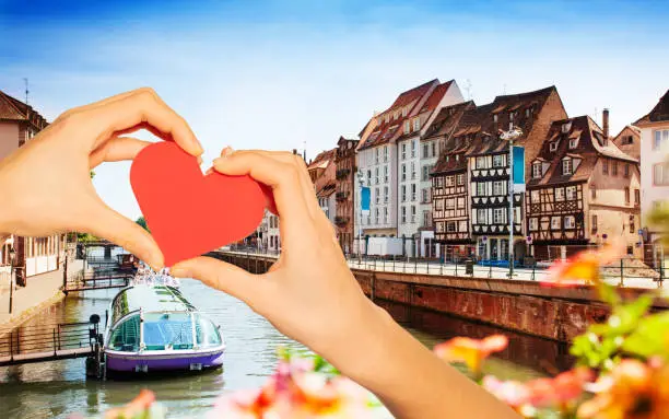 Photo of Hand hold red heart over Strasbourg and Ill river