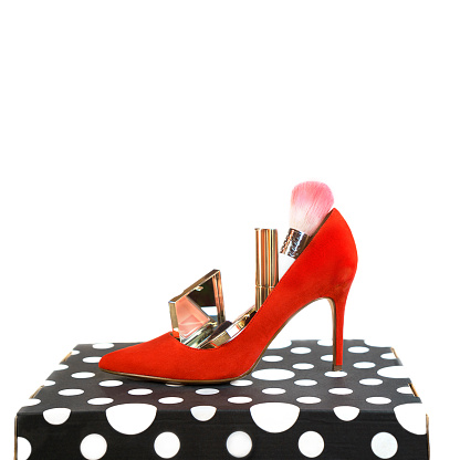 Trendy outfit layout red shoes accessories makeup cosmetics on black and white box and white background. Christmas, New Year, Valentine's Day Party, Black Friday concept, isolated, copy space.
