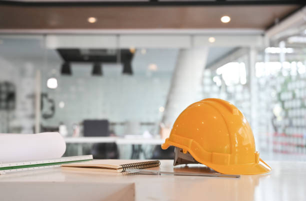 istock Engineer helmet and drawing equipment. Architectural Office desk construction project. 1143510957