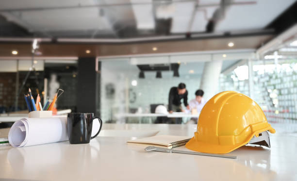 istock Engineer helmet and drawing equipment. Architectural Office desk construction project. 1143511952