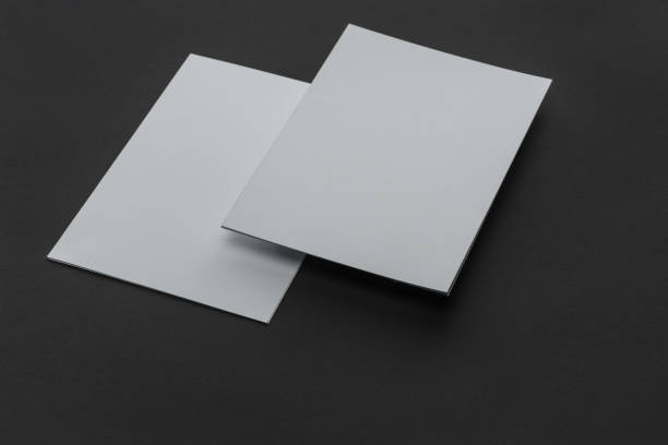 istock empty sheets of paper with copy space on black background 1143512035