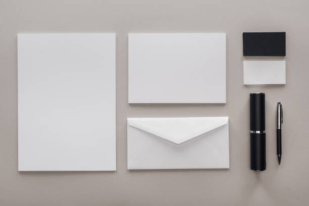 istock flat lay with blank white papers, envelope and stationery on grey background 1143512219