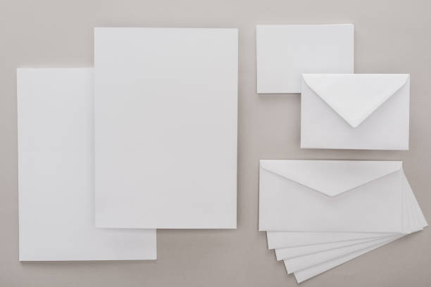 istock top view of white empty papers and envelopes on grey background 1143512570