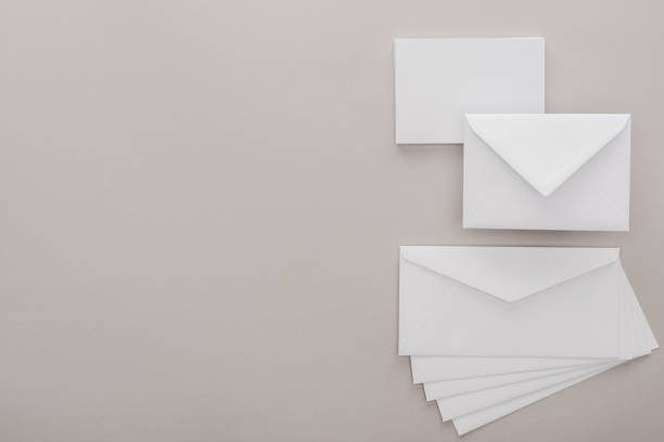 istock top view of white envelopes on grey background with copy space 1143512571