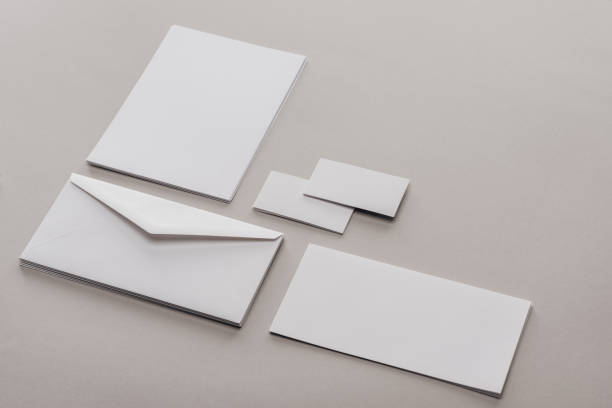 istock Envelope, cards and sheets of paper on grey background 1143512573