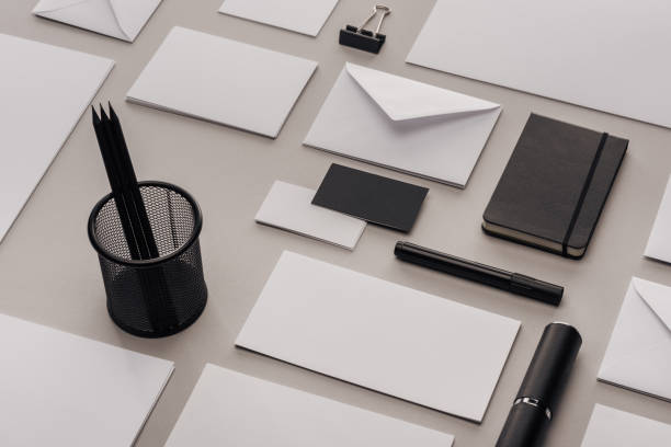 istock flat lay with white and black office supplies on grey background 1143512579