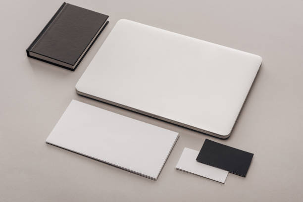 istock flat lay with black and white empty cards and laptop on grey background 1143512582