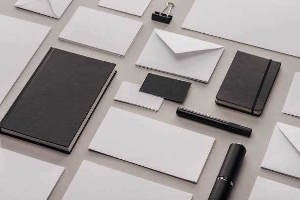 istock flat lay with white empty papers and black office supplies on grey background 1143512584