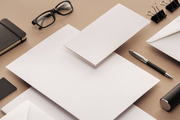 istock Flat lay with glasses, pen, notebook, case, paper clips, envelopes and sheets of paper 1143512608