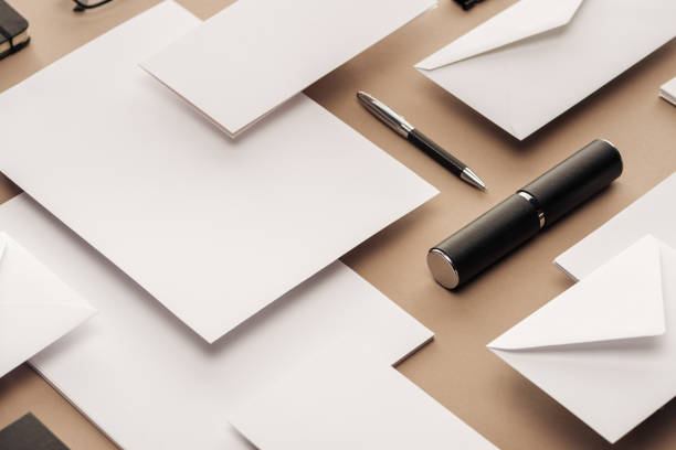 istock Pen, case, envelopes and sheets of paper on beige background 1143512610
