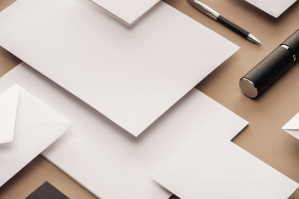 istock Case, envelope, sheets of paper and pen on beige background 1143512611