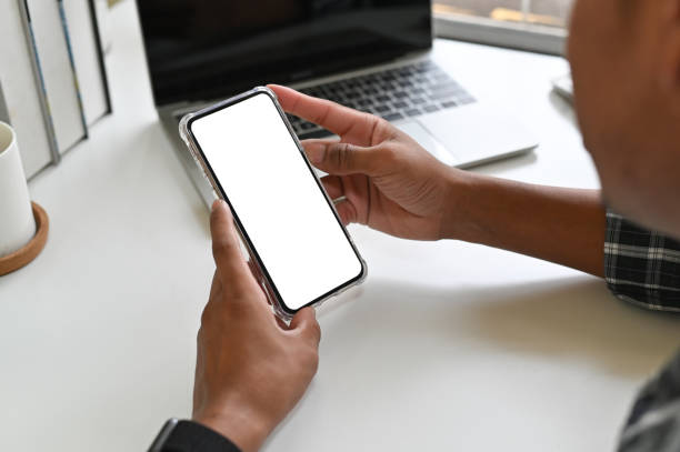 istock Cropped shot hands using mockup smartphone on office desk with clipping path. 1143512721