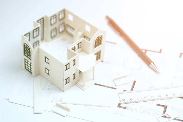 istock house model,blueprint,pencil and ruler on clean white background 1143513442