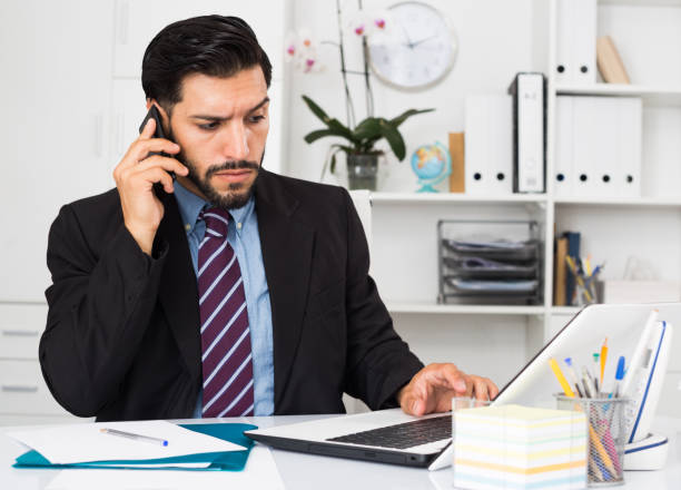 istock Adult man is serious talking phone 1143513543