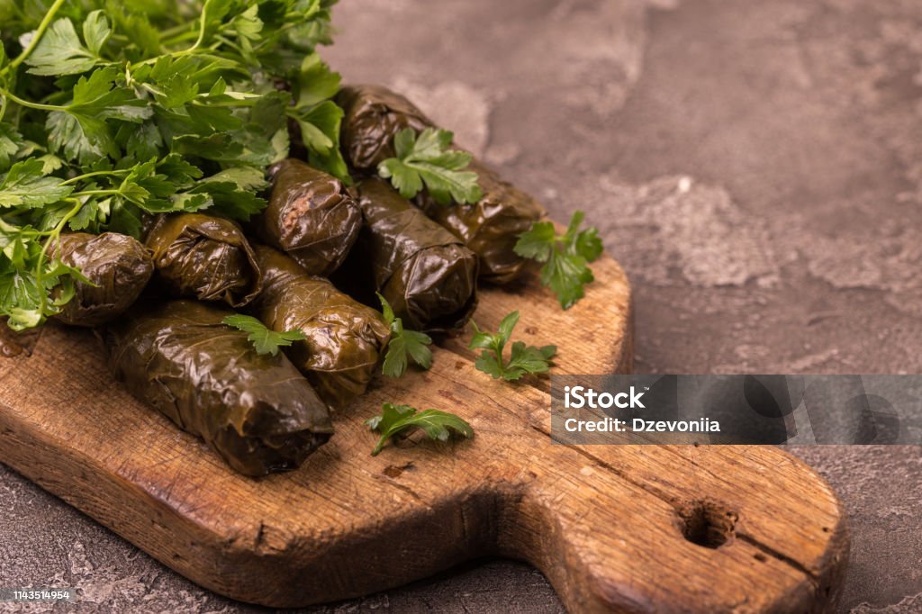 Traditional georgian cuisine. Dolma in grape leaves Traditional georgian cuisine. Dolma in grape leaves with pomegranate and parsley Armenian Culture Stock Photo