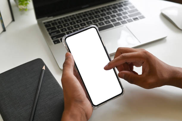 istock Closeup hands using mockup smartphone on office desk with clipping path. 1143514972