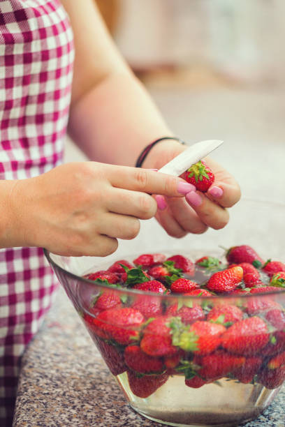 istock Washing strawberries for making homemade pie 1143515186