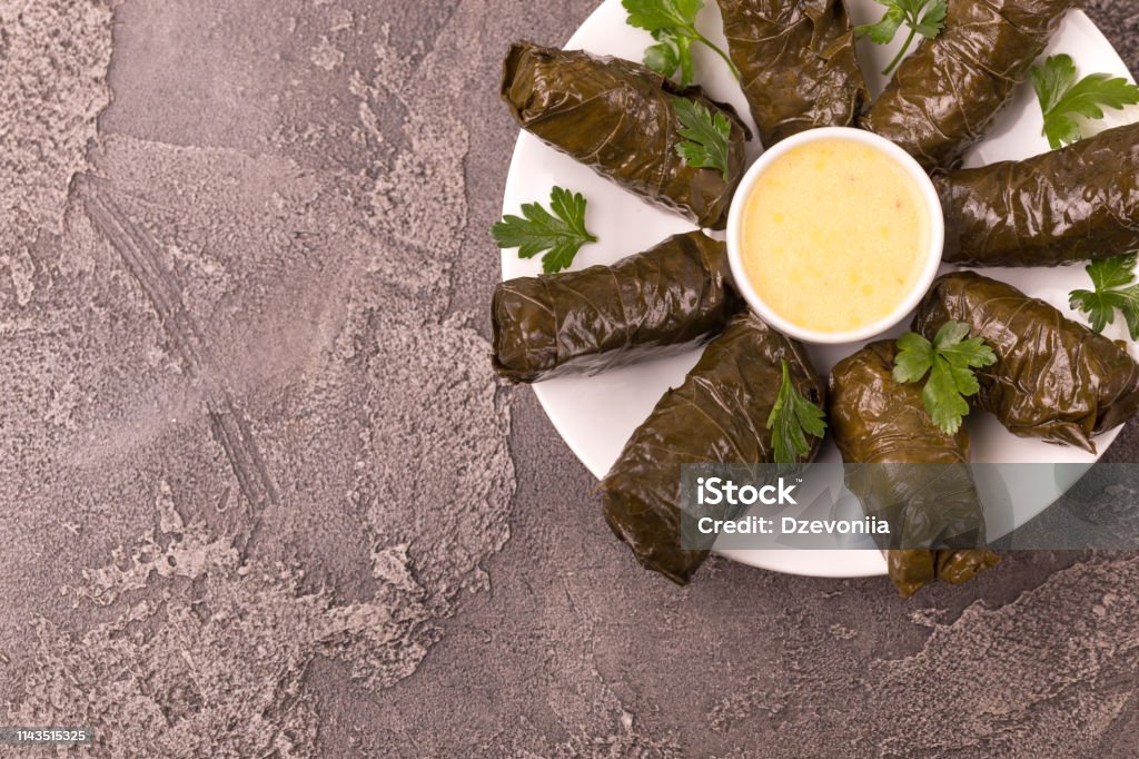 Traditional georgian cuisine. Dolma in grape leaves Traditional georgian cuisine. Dolma in grape leaves with pomegranate and parsley Armenian Culture Stock Photo