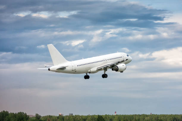 istock White passenger aircraft in the air on take-off 1143516726