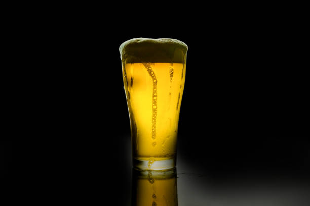 istock beer glass with white foam on dark background 1143517031