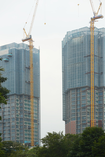unidentified Two towers in construction progress with canes