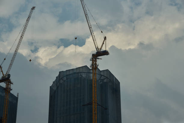 istock unidentified towers in construction progress with canes 1143517245