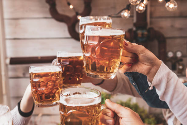 istock group of happy friends drinking beer 1143518759