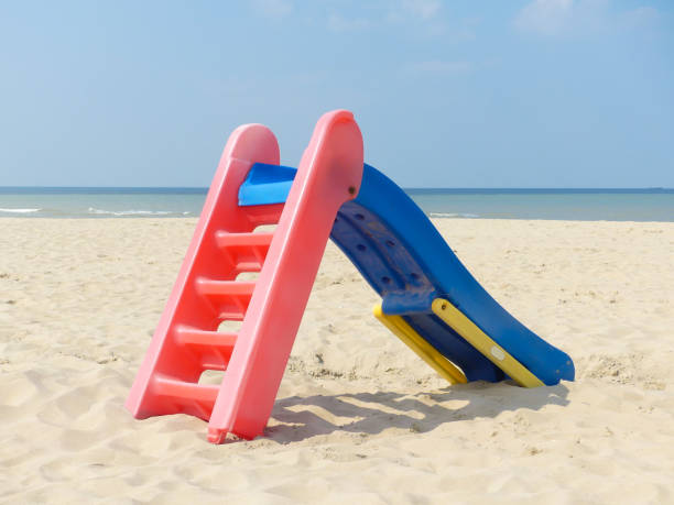 istock playground slide on beautiful deserted beach 1143519810
