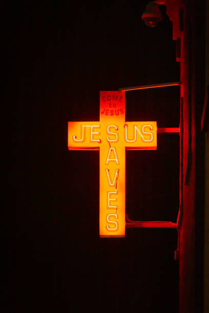 istock Jesus Saves Neon Cross Sign 1143519819