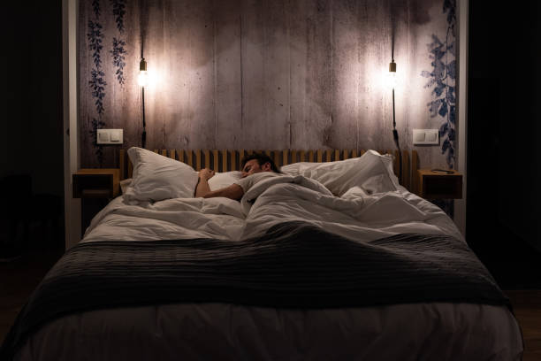 istock Man sleeping in bed in a modern beautiful bedroom 1143519986