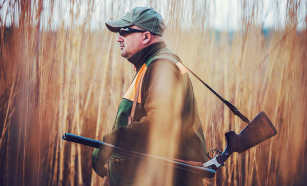 istock Hunter with a rifle in hunting 1143520818