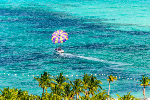 Parasailing in Miami, Florida Miami, Florida - February 28, 2018: An unidentified man prepares to get harnessed for a parasailing adventure in Miami, Florida. miami parachuting stock pictures, royalty-free photos & images