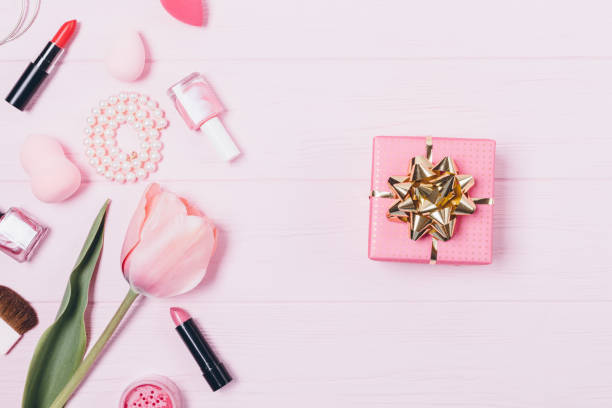 istock Gift box with golden bow near makeup products 1143522400