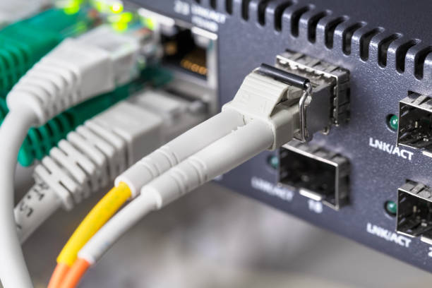 istock Close-up of high speed fiber network switch and cables in datacenter 1143524037