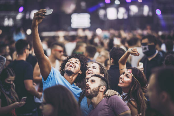 istock Young happy people having fun while taking a selfie on music festival. 1143524481