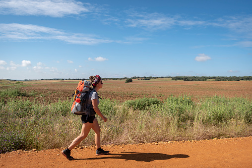 A young woman walking across Spain on the Camino de Santiago is here seen outside the village of Santibáñez de Valdeiglesias, several kilometers from Astorga, Spain. (June 29, 2018)