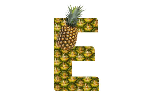 istock Alphabet letter E made from pineapple on a white background. Tropical fruit pineapple diet summer food. 1143525320