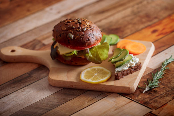 istock Dark burger with salad, rosemary and lemon 1143528867