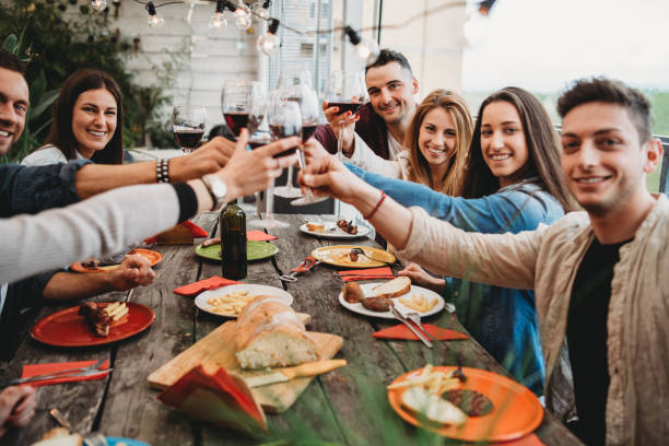 istock Friends doing a celebratory toast during dinner on the rooftop at home 1143529010