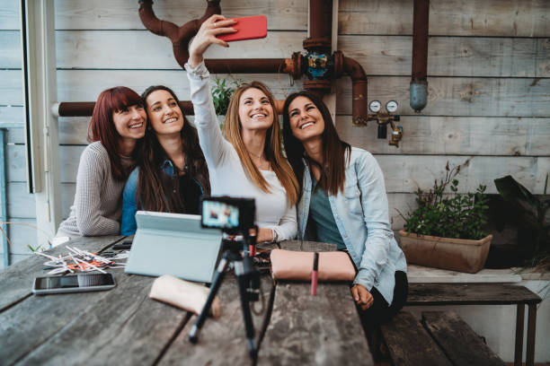 istock Four friends doing a vlog video together 1143529096